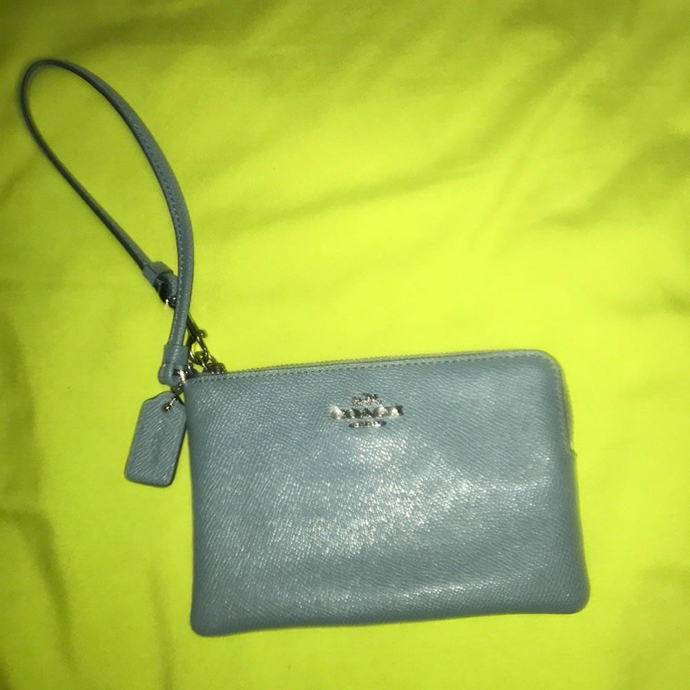 This is a dark turquoise COACH WRISTLET!